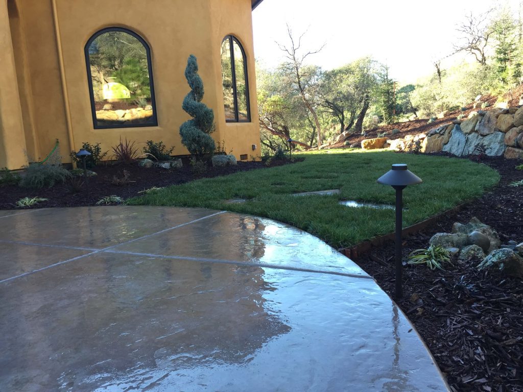Durable concrete patio enhancing the outdoor living space of a Loomis home, designed and installed by Aronson Landscape