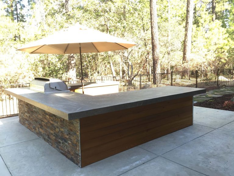 Modern outdoor kitchen with a concrete countertop, a stylish addition to a Lincoln backyard, designed and installed by Aronson Landscape