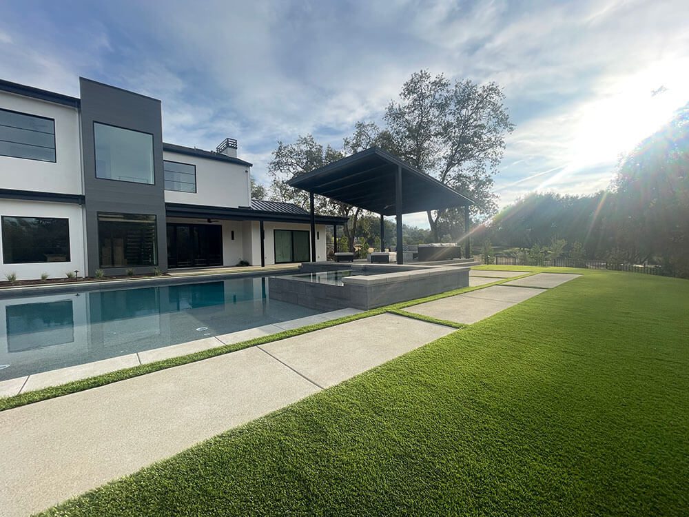 Outdoor patio with concrete pavers around a pool in rocklin ca